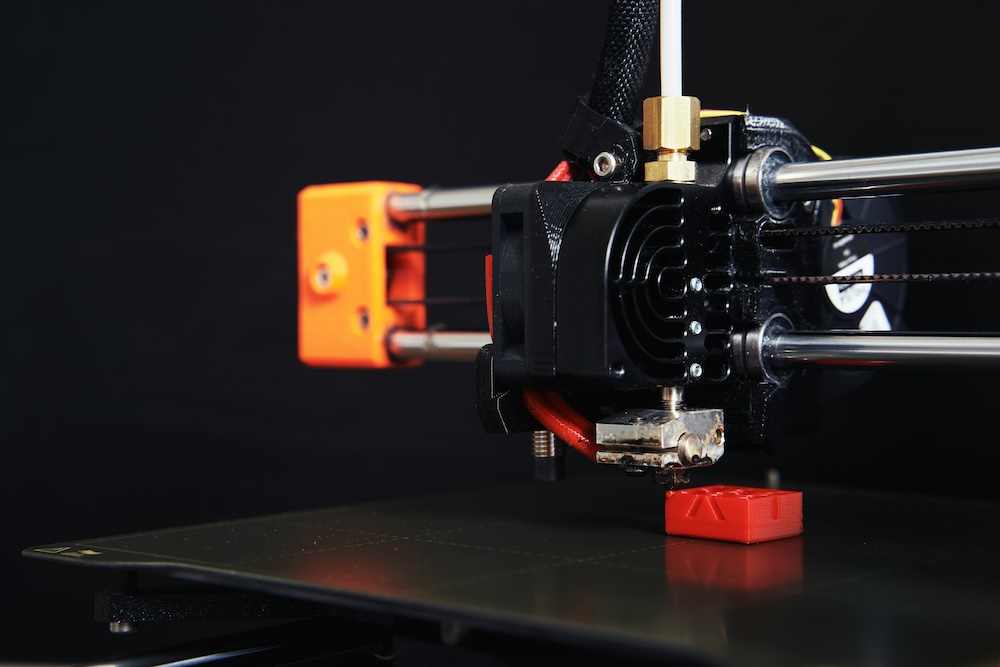 A red item being made with 3D printing.