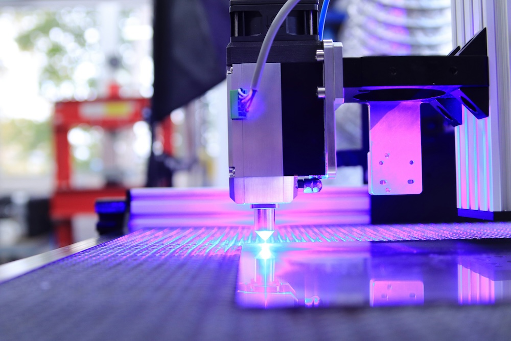 A CNC laser machine manufacturing components from CNC materials.